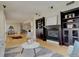 Spacious open floor plan with living room, dining area, and kitchen featuring hardwood floors and fireplace at 191 Clayton Ln # 402, Denver, CO 80206
