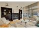 Stylish living room with fireplace, built-in shelving, and abundant natural light at 191 Clayton Ln # 402, Denver, CO 80206
