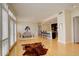 Bright open concept living room leading into dining area and kitchen with hardwood floors throughout at 191 Clayton Ln # 402, Denver, CO 80206