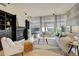 Bright living room with fireplace, hardwood floors, and large windows showcasing the city view at 191 Clayton Ln # 402, Denver, CO 80206