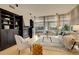 Cozy living room with built-in shelving, fireplace, and large windows at 191 Clayton Ln # 402, Denver, CO 80206