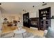 Inviting living room features a fireplace, built-in bookshelves, and open floor plan at 191 Clayton Ln # 402, Denver, CO 80206