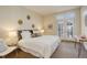 Cozy bedroom featuring a king-sized bed, neutral tones, carpet, and outdoor access at 191 Clayton Ln # 402, Denver, CO 80206