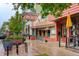 Street view of Cherry Cricket restaurant showcases its classic signage, red brick exterior, and sidewalk patio seating area at 191 Clayton Ln # 402, Denver, CO 80206