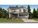 Inviting two-story home showcasing a stone-accented facade, attached two-car garage, and manicured front lawn at 7743 S Cherokee Trl, Centennial, CO 80016