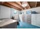Basement featuring concrete walls, a window, and an abundance of built-in shelving at 7105 Flagstaff Rd, Boulder, CO 80302