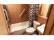 The bathroom features brown wall tiles and a tub with a white shower curtain at 7105 Flagstaff Rd, Boulder, CO 80302