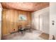 Simple bedroom with wood paneling and a view to the outdoors, awaiting your personal touch at 7105 Flagstaff Rd, Boulder, CO 80302