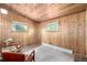 Cozy bedroom with wood-paneled walls and natural light, perfect for a serene retreat at 7105 Flagstaff Rd, Boulder, CO 80302
