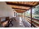 Spacious covered deck overlooks surrounding trees at 7105 Flagstaff Rd, Boulder, CO 80302