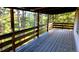 Spacious wooden deck overlooking a lush, wooded area, perfect for outdoor relaxation at 7105 Flagstaff Rd, Boulder, CO 80302
