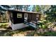 View of home's exterior with a ramp leading to the front door with dark siding and a walk-out basement at 7105 Flagstaff Rd, Boulder, CO 80302