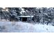 Snowy cabin exterior in a winter wonderland, offering a cozy retreat surrounded by pristine nature at 7105 Flagstaff Rd, Boulder, CO 80302