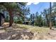 Exterior of the home with mature trees and grassy lawn at 7105 Flagstaff Rd, Boulder, CO 80302