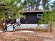 Charming exterior view of a cozy home with dark wood siding and a small wooden ramp entrance at 7105 Flagstaff Rd, Boulder, CO 80302