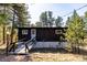 Quaint cabin with a wooden ramp nestled among the trees, offering a cozy and secluded retreat at 7105 Flagstaff Rd, Boulder, CO 80302