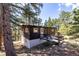 Charming cabin with wooden ramp in a wooded setting, offering a rustic and peaceful escape at 7105 Flagstaff Rd, Boulder, CO 80302