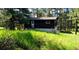 Quaint home with wood siding and front entrance ramp surrounded by mature trees at 7105 Flagstaff Rd, Boulder, CO 80302