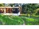 Exterior view of home with brick paver path and lush green landscape at 7105 Flagstaff Rd, Boulder, CO 80302