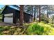 Garage with white door and side door with grass and trees in the background at 7105 Flagstaff Rd, Boulder, CO 80302
