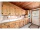 Vintage kitchen with wood cabinets and a bright window, offering a cozy cooking space at 7105 Flagstaff Rd, Boulder, CO 80302
