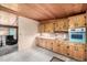 Charming kitchen with wood cabinets, vintage oven range, and adjacent living space at 7105 Flagstaff Rd, Boulder, CO 80302