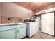 Well-equipped laundry room with vintage sink, washer, dryer and refrigerator at 7105 Flagstaff Rd, Boulder, CO 80302