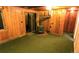 Cozy living area features knotty pine wood paneling, a fireplace and a large sliding door leading to the outside at 7105 Flagstaff Rd, Boulder, CO 80302