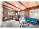 Living room boasts wood paneling, a fireplace, comfortable furniture, and large windows at 7105 Flagstaff Rd, Boulder, CO 80302