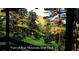 Beautiful view of Bear Mountain from the deck, surrounded by lush greenery and tall trees at 7105 Flagstaff Rd, Boulder, CO 80302