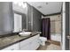 Modern bathroom with dark gray walls, white cabinets and a sink at 1441 Central St # 209, Denver, CO 80211