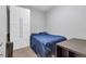 Cozy bedroom with large wardrobe, carpeted floor, and desk, perfect for a minimalist lifestyle at 1441 Central St # 209, Denver, CO 80211