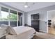 Bedroom with sliding glass doors to balcony, ceiling fan, and en-suite office at 1441 Central St # 209, Denver, CO 80211
