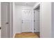 Apartment entry with a white door, hardwood floors, and coat hooks at 1441 Central St # 209, Denver, CO 80211
