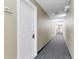 Hallway with neutral paint, gray carpet, and door to unit 209 on the left at 1441 Central St # 209, Denver, CO 80211