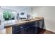 Kitchen with granite counters and stainless steel sink overlooking living area at 1441 Central St # 209, Denver, CO 80211