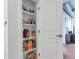Pantry with fully stocked shelves with white door leading to another room at 1441 Central St # 209, Denver, CO 80211