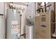 Efficient utility room featuring water heater, washer/dryer and furnace at 1441 Central St # 209, Denver, CO 80211