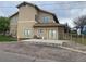 Spacious backyard with a large patio and a charming gold metal fence at 1123 S Quince Way, Denver, CO 80231