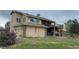 Exterior of the home with a wooden deck overlooking the backyard at 1123 S Quince Way, Denver, CO 80231
