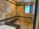 Luxurious bathroom with tiled walls, a bench, and a modern shower system at 1123 S Quince Way, Denver, CO 80231