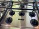 Close-up of KitchenAid gas cooktop with stainless steel finish and knob controls at 1123 S Quince Way, Denver, CO 80231
