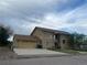 Two-story home featuring a spacious two-car garage and a well-manicured lawn at 1123 S Quince Way, Denver, CO 80231