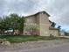 Two-story home with a landscaped front yard and blooming trees on a sunny day at 1123 S Quince Way, Denver, CO 80231