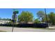 A charming single-story home with a fenced yard, as seen from the street corner on a bright, sunny day at 1123 S Quince Way, Denver, CO 80231