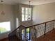 Bright foyer featuring a staircase, hardwood floors, and unique pendant lighting at 1123 S Quince Way, Denver, CO 80231