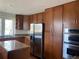 Modern kitchen featuring stainless steel appliances, granite countertops, and custom cabinetry at 1123 S Quince Way, Denver, CO 80231