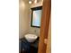 Modern powder room with a vessel sink, stylish faucet, and a dark wood vanity at 1123 S Quince Way, Denver, CO 80231