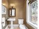 Elegant powder room features designer wallpaper, pedestal sink, and large window with a view of the outside at 465 Monroe St, Denver, CO 80206