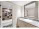 Bathroom featuring a sink with granite counters, mosaic tile accent, and a large mirror at 465 Monroe St, Denver, CO 80206